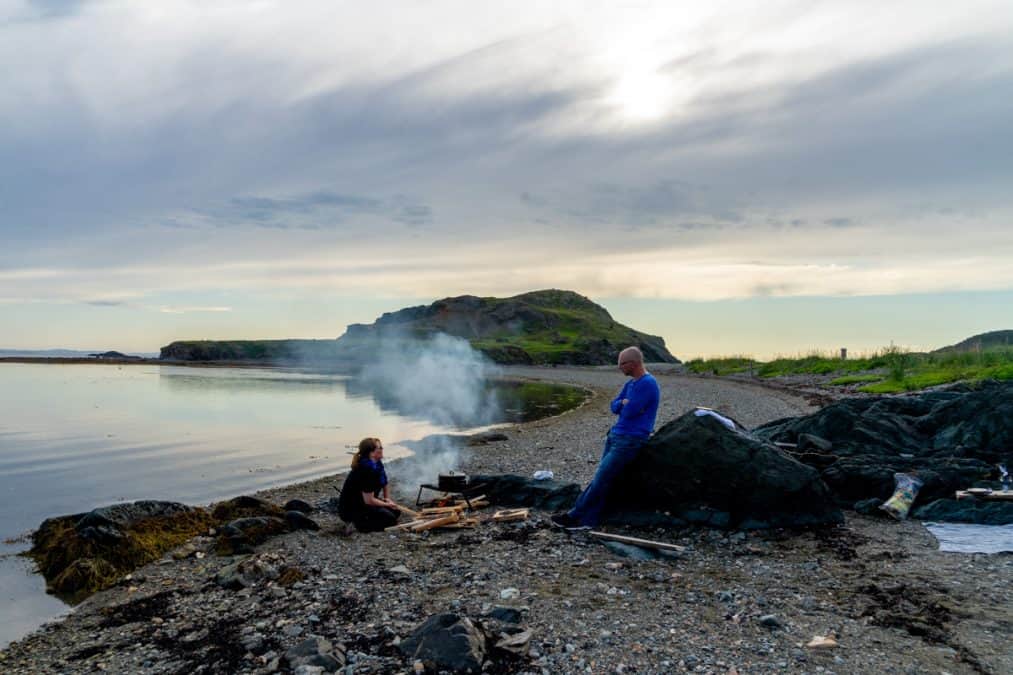 two friends having a campfire in twillingate newfoundland