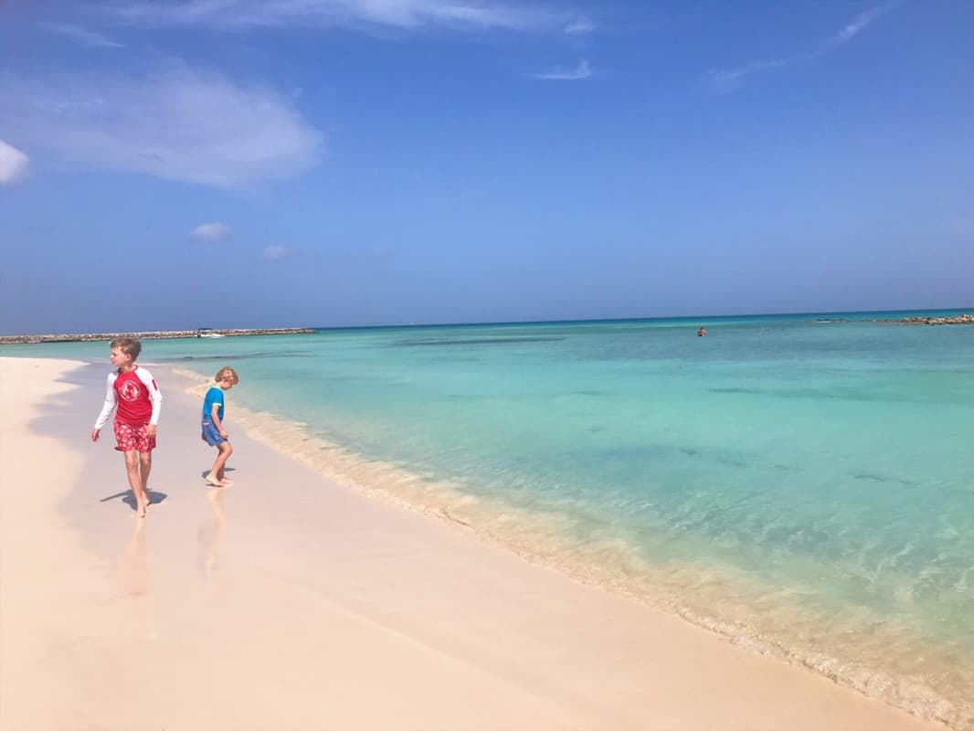 two young kids  walking on beach in Aruba